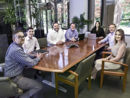 Team photo around table